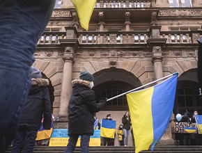 protestors flying pro ukraine flags at rally